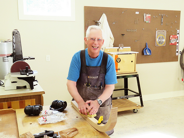 OceanView resident sanding wood in new Workshop.