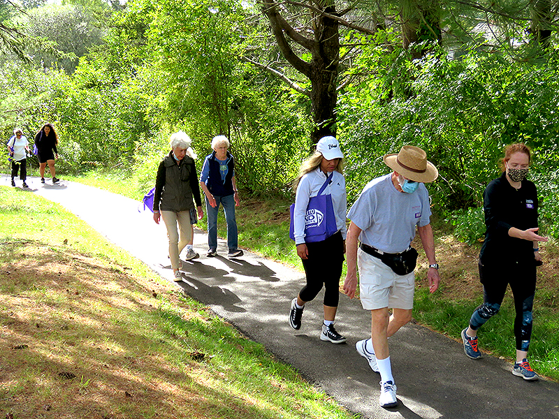 continuum of care retirement | Residents and staff walking on OceanView's campus