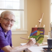 when to move to a retirement community | Image - Resident Painting at Falmouth House 4x3