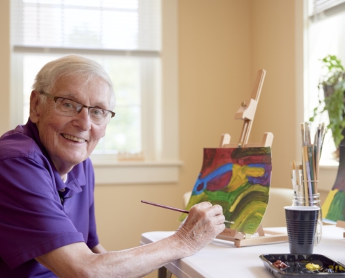 when to move to a retirement community | Image - Resident Painting at Falmouth House 4x3